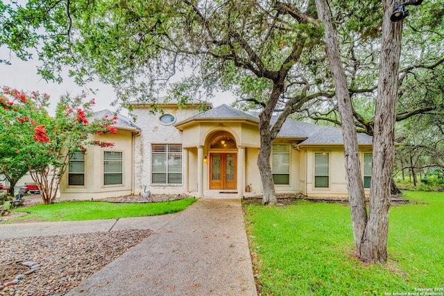 view of front of house featuring french doors and a front yard