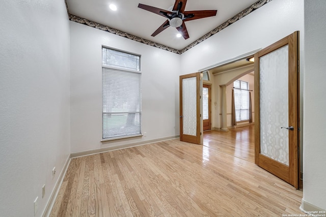 unfurnished room featuring french doors, ceiling fan, and light hardwood / wood-style floors