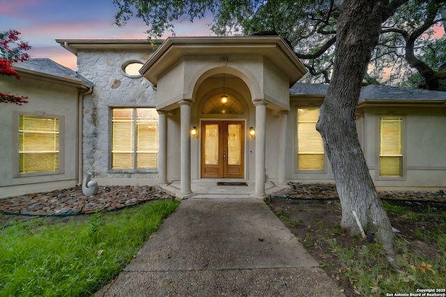 exterior entry at dusk featuring french doors