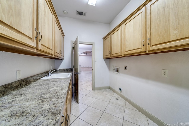 clothes washing area featuring sink, washer hookup, cabinets, hookup for an electric dryer, and light tile patterned floors