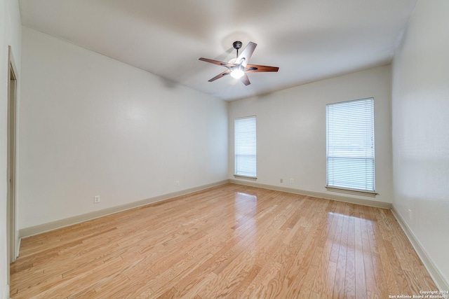 empty room featuring ceiling fan, light hardwood / wood-style flooring, and plenty of natural light