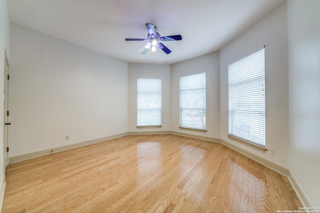 spare room featuring ceiling fan and light hardwood / wood-style flooring