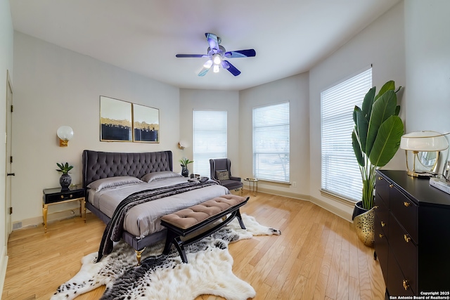 bedroom with ceiling fan and light hardwood / wood-style floors