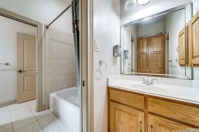 bathroom featuring vanity, tile patterned flooring, and tiled shower / bath combo