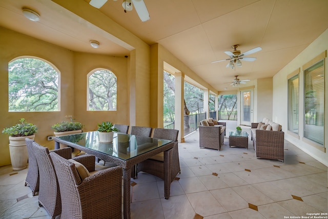 sunroom featuring ceiling fan