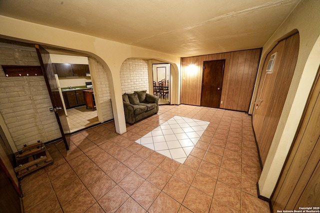 interior space with wood walls and brick wall