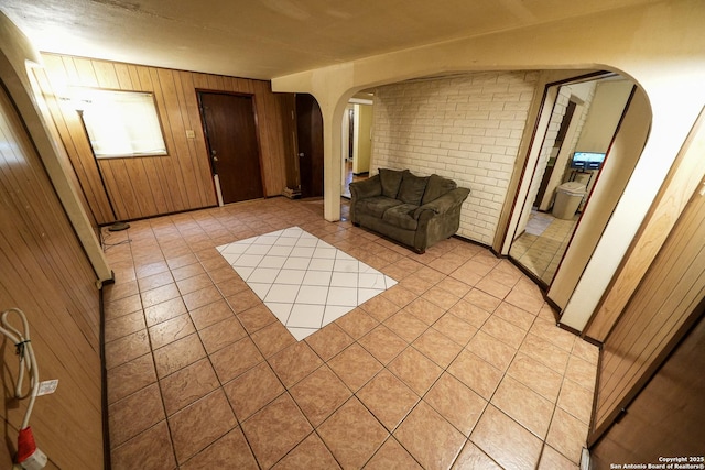 interior space with brick wall and wooden walls