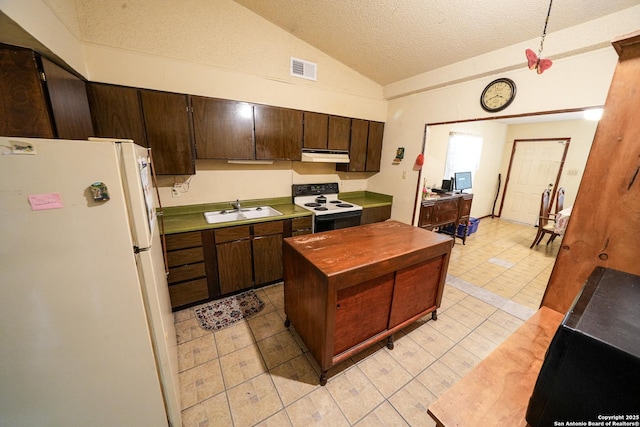 kitchen with electric range, white fridge, vaulted ceiling, a textured ceiling, and sink