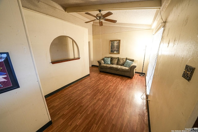 corridor featuring a textured ceiling, vaulted ceiling with beams, and wood-type flooring