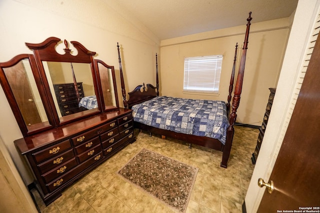 bedroom featuring a textured ceiling and vaulted ceiling