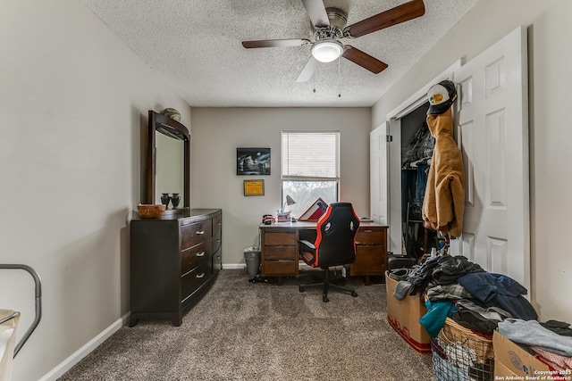 office featuring a textured ceiling, ceiling fan, and dark carpet