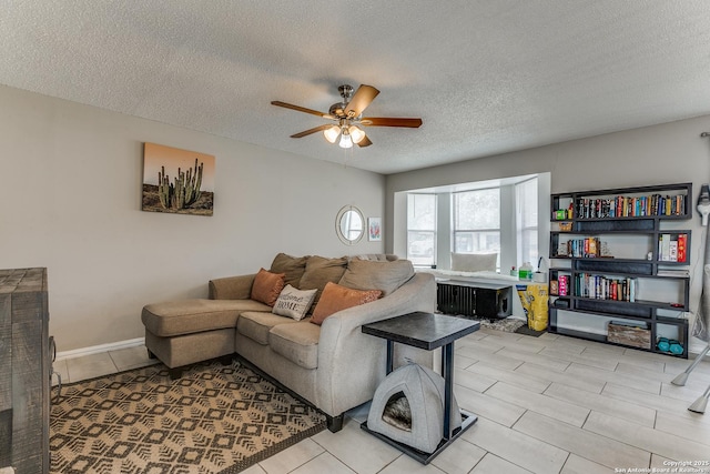 living room featuring a textured ceiling, ceiling fan, radiator, and light tile patterned floors