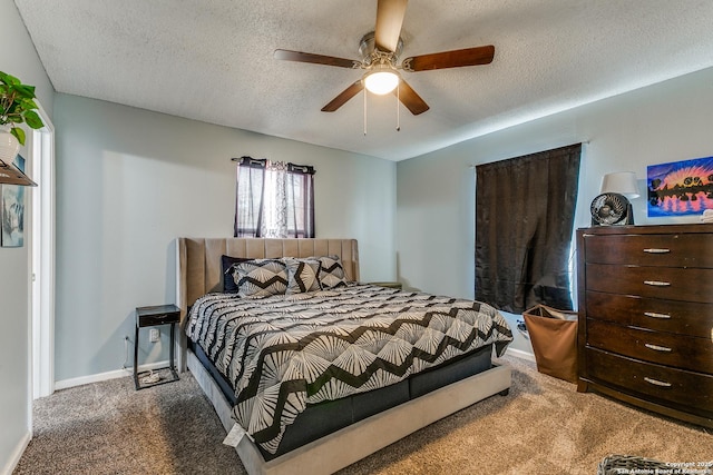 bedroom featuring a textured ceiling, ceiling fan, and carpet floors