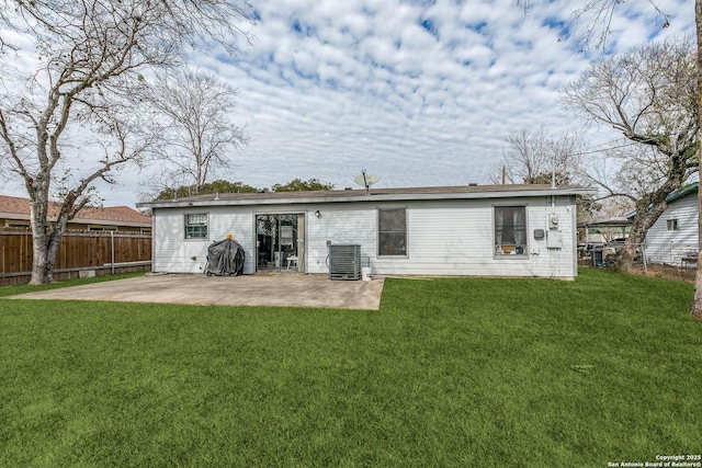 back of house featuring a yard, central AC, and a patio area