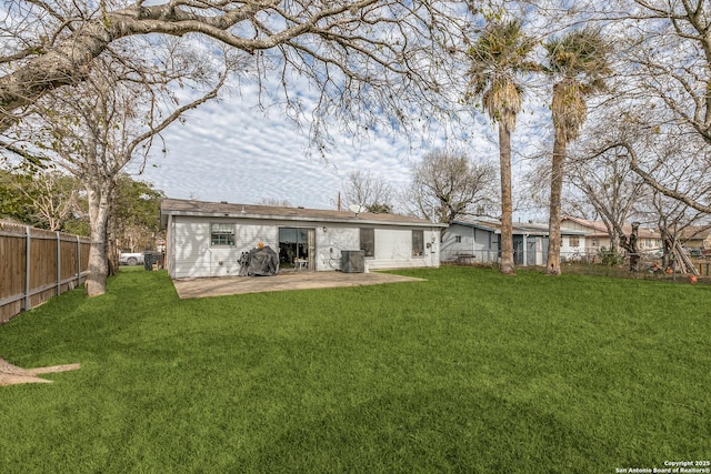 back of property with a patio and a lawn