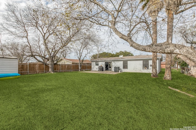 view of yard with central air condition unit and a patio area