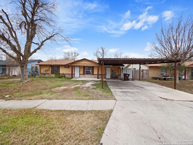 ranch-style house featuring a carport and a front lawn