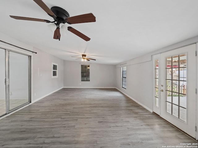 unfurnished living room with light wood-type flooring and ceiling fan