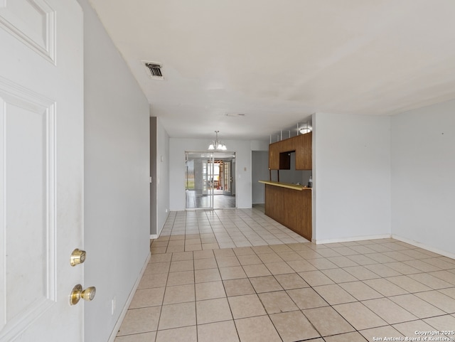 interior space featuring a notable chandelier and light tile patterned floors