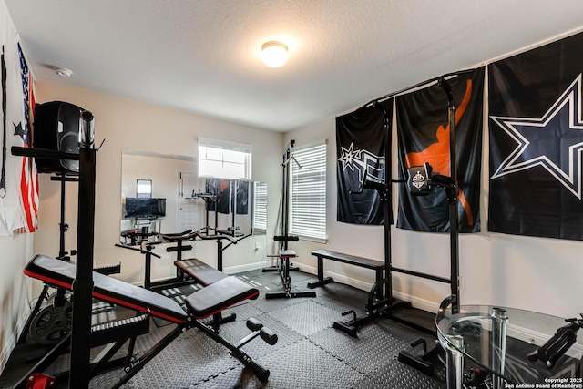 exercise area featuring a textured ceiling