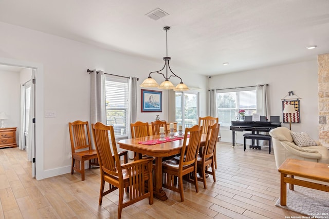 dining area with light hardwood / wood-style floors and a healthy amount of sunlight