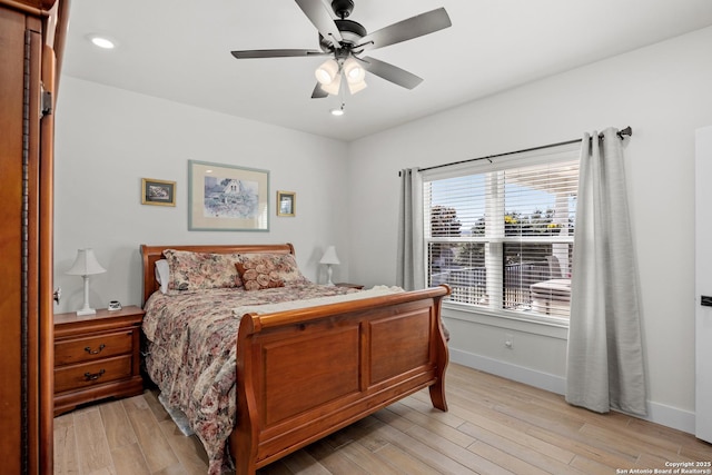 bedroom with ceiling fan and light hardwood / wood-style flooring