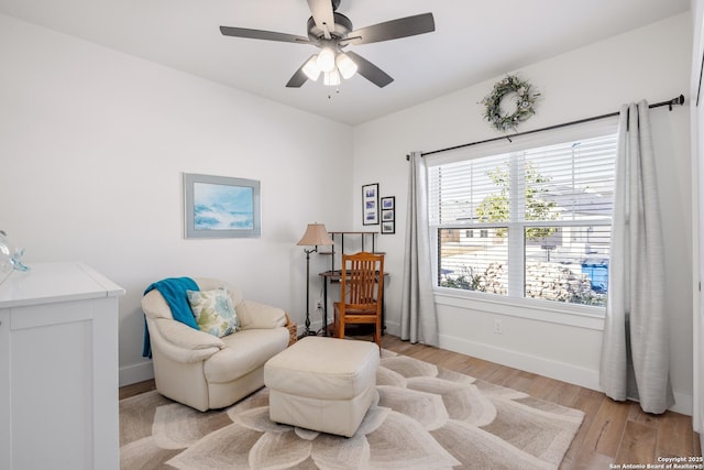 living area featuring ceiling fan and light hardwood / wood-style flooring