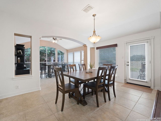 dining area featuring ornate columns, vaulted ceiling, ceiling fan, and light tile patterned floors