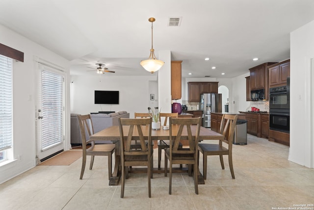 tiled dining room featuring ceiling fan