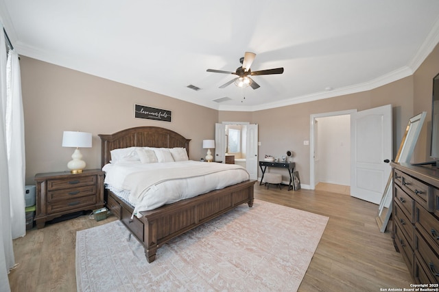 bedroom with ceiling fan, ornamental molding, and light hardwood / wood-style flooring