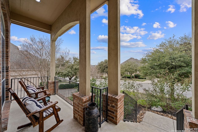 view of patio featuring a balcony and a mountain view