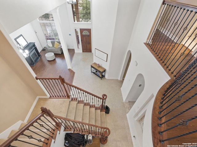 stairs featuring a towering ceiling