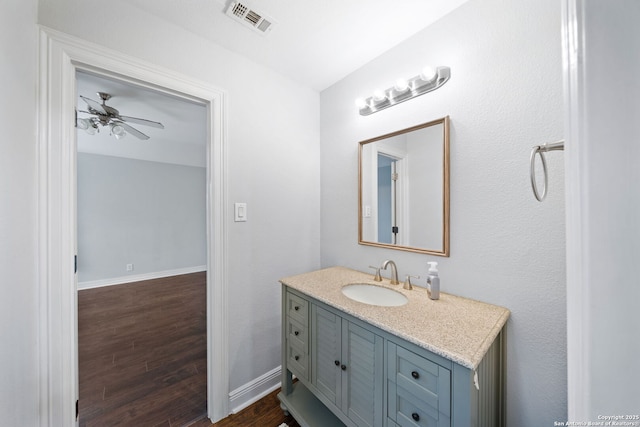 bathroom with ceiling fan, wood-type flooring, and vanity