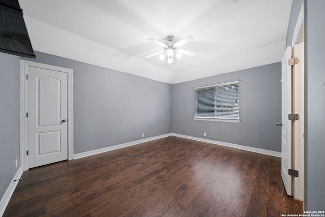 unfurnished room with lofted ceiling, ceiling fan, and dark hardwood / wood-style floors