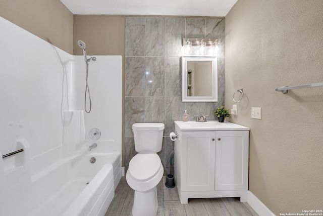 full bathroom with tile walls, shower / bathing tub combination, vanity, and toilet