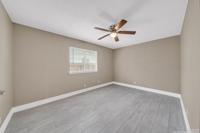 empty room featuring light wood-type flooring and ceiling fan