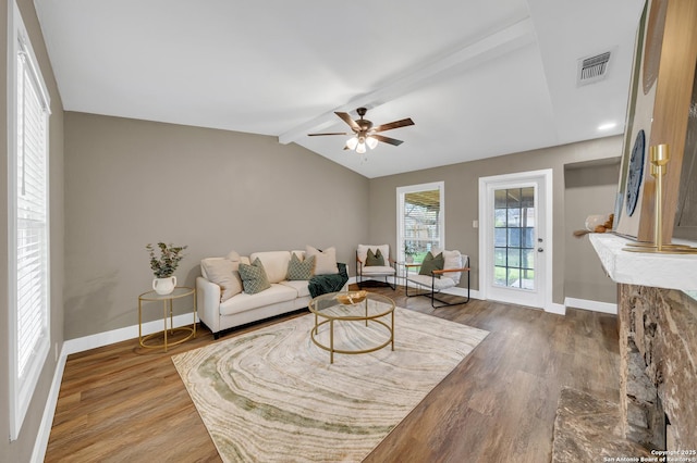 living room with ceiling fan, lofted ceiling with beams, and wood-type flooring