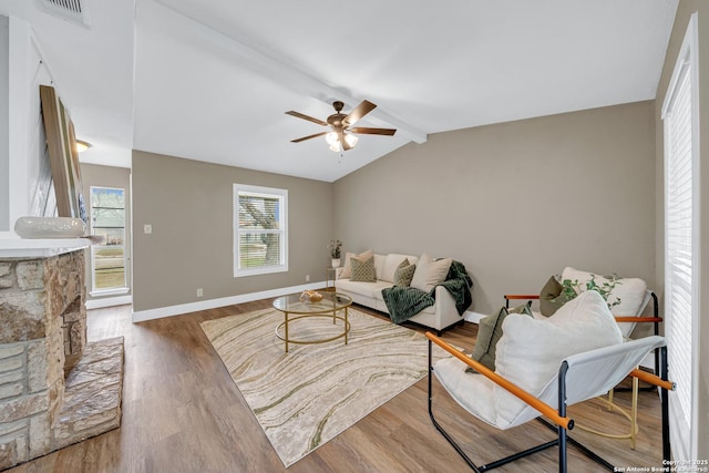 living room featuring ceiling fan, lofted ceiling with beams, and wood-type flooring