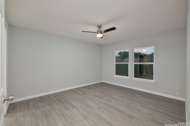 empty room featuring ceiling fan and hardwood / wood-style flooring