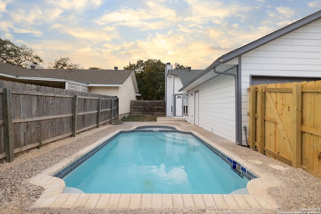 view of pool at dusk