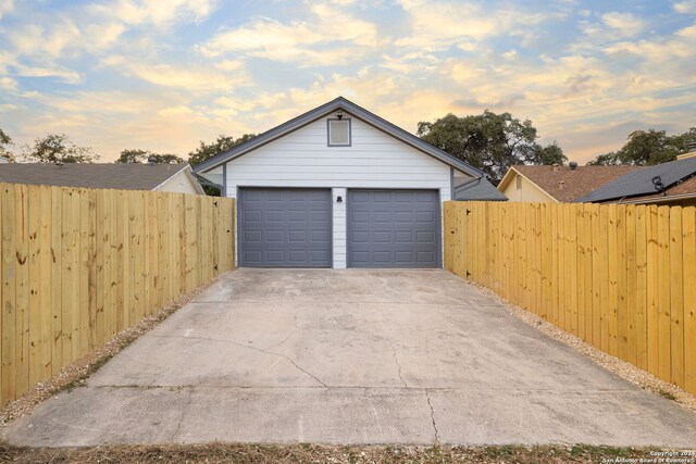 view of garage at dusk