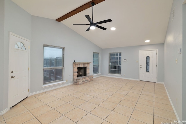 unfurnished living room with light tile patterned floors, a fireplace, ceiling fan, and vaulted ceiling with beams