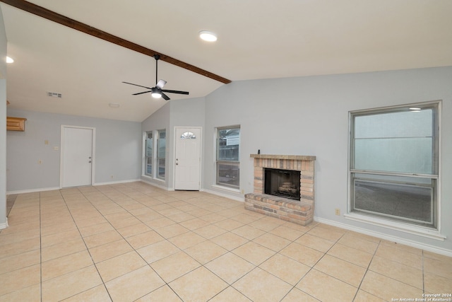 unfurnished living room with light tile patterned floors, a fireplace, lofted ceiling with beams, and ceiling fan