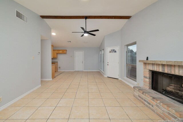 unfurnished living room with light tile patterned floors, a fireplace, ceiling fan, and vaulted ceiling with beams