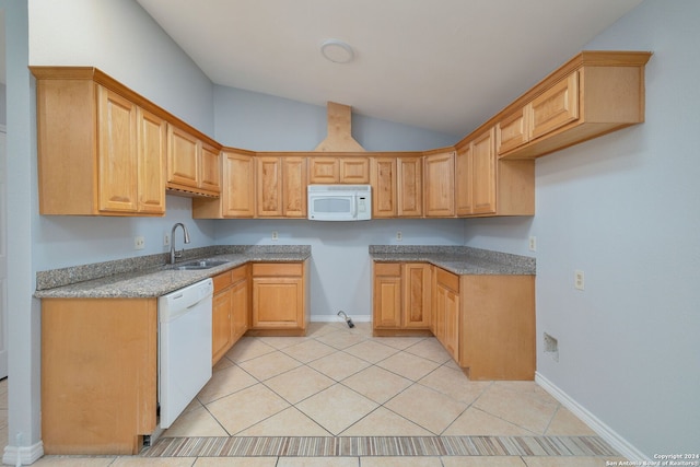 kitchen with white appliances, vaulted ceiling, light brown cabinets, sink, and light tile patterned flooring