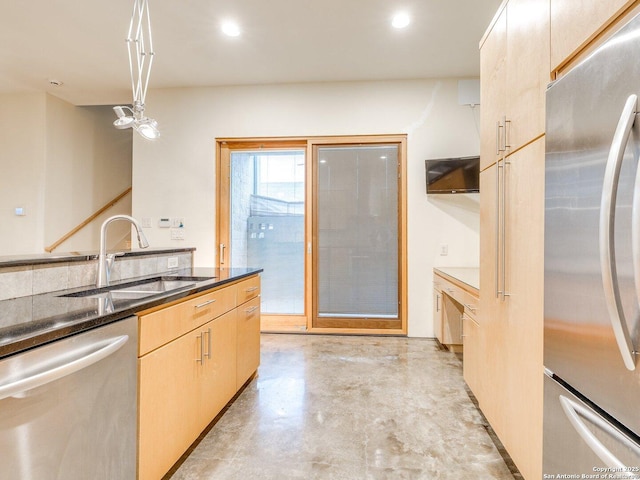 kitchen with sink, decorative light fixtures, light brown cabinetry, and appliances with stainless steel finishes