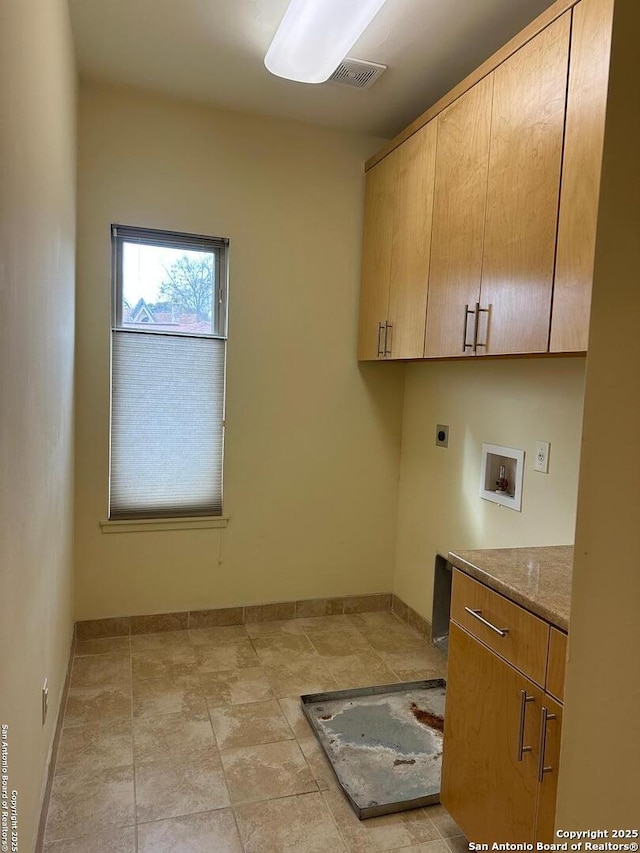 washroom with washer hookup, cabinets, and electric dryer hookup