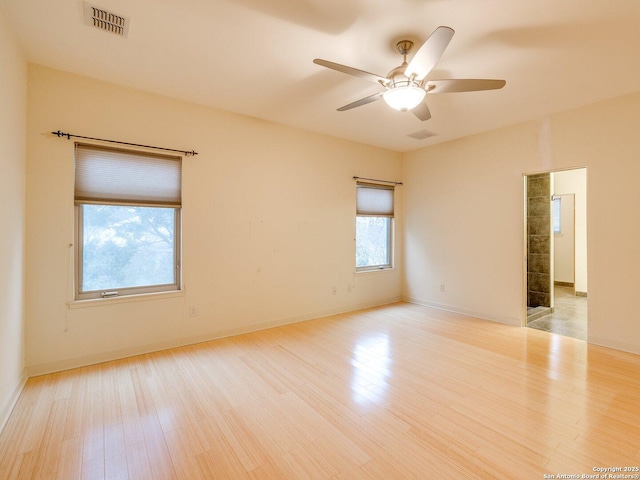 empty room featuring light wood-type flooring and ceiling fan