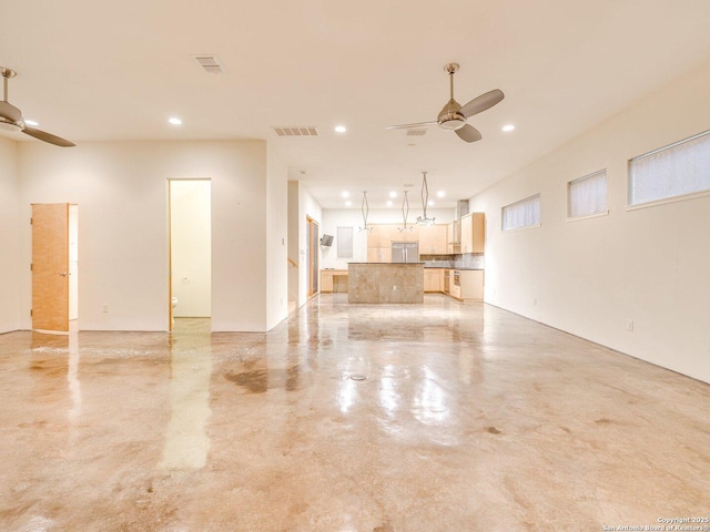 unfurnished living room featuring ceiling fan