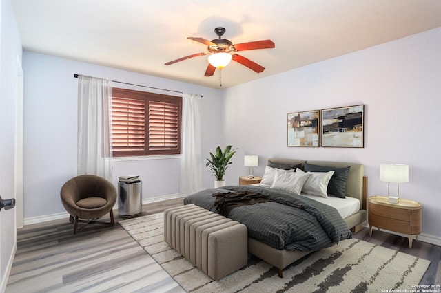 bedroom with light hardwood / wood-style floors and ceiling fan